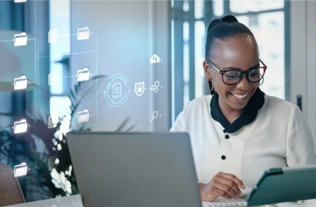 woman working on a laptop in a modern office, surrounded by digital document icons, representing smart document management, data security and efficient digital workflows.